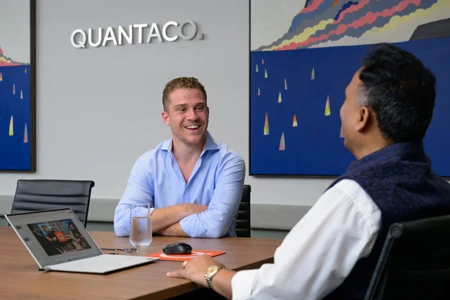 Two men sitting in a meeting laughing